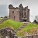 The ruins of Urquhart Castle under stormy clouds